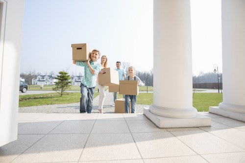 Moving team carrying boxes in an Upper Clapton flat