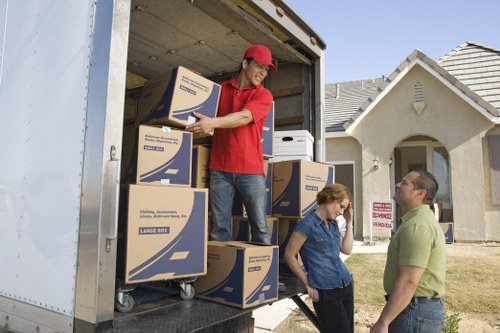 Packing boxes and furniture being loaded into a moving van