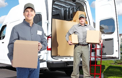 Professional man with van loading items for transport in Hackney